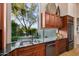 Kitchen sink with granite countertop, stainless appliances, tile floor, and backyard views at 40635 N 109Th Pl, Scottsdale, AZ 85262