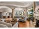 Open living space featuring hardwood floors, arched ceilings, fireplace, and expansive windows offering natural light at 40635 N 109Th Pl, Scottsdale, AZ 85262
