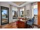 Bright home office with wood-look floors, many windows, and an ornate desk at 40635 N 109Th Pl, Scottsdale, AZ 85262