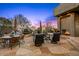 Stone patio with built-in fireplace, outdoor seating area, and relaxing water feature at 40635 N 109Th Pl, Scottsdale, AZ 85262