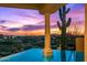 Inviting pool view featuring desert landscape, sunset sky and stucco column detail at 40635 N 109Th Pl, Scottsdale, AZ 85262