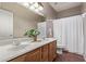 Bathroom with double sinks, framed mirror, and shower with white curtain at 4086 E County Down Dr, Chandler, AZ 85249