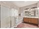 Elegant bathroom with a glass-enclosed shower, soaking tub, and dual-sink vanity at 4086 E County Down Dr, Chandler, AZ 85249