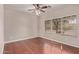 Bright bedroom features hardwood floors, ceiling fan, and a large window at 4086 E County Down Dr, Chandler, AZ 85249