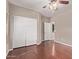 Bedroom with hardwood floors, closet, and view to the hallway at 4086 E County Down Dr, Chandler, AZ 85249