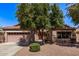 Charming single-story home with a desert landscaped yard and mature shade tree at 4086 E County Down Dr, Chandler, AZ 85249