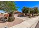 Traditional home with desert landscaping, driveway, and two-car garage at 4086 E County Down Dr, Chandler, AZ 85249