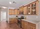 Charming kitchen featuring wood cabinetry, stainless steel appliances, and neutral countertops at 4086 E County Down Dr, Chandler, AZ 85249