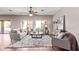 Spacious living room with neutral furniture, large rug, ceiling fan, and natural light at 4086 E County Down Dr, Chandler, AZ 85249