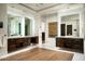 Well-lit bathroom with double vanity sinks, marble countertops, and a decorative mosaic wall art at 41248 N 96Th St, Scottsdale, AZ 85262