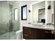 Contemporary bathroom featuring a glass shower enclosure, dark wood vanity, and sleek fixtures at 41248 N 96Th St, Scottsdale, AZ 85262