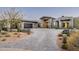 Stunning contemporary home with a paver driveway and stone accents, surrounded by desert landscaping at 41248 N 96Th St, Scottsdale, AZ 85262