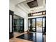 Open foyer with black marble floors, glass-enclosed wine display, and open doors framing the desert landscape at 41248 N 96Th St, Scottsdale, AZ 85262