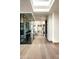 Bright hallway featuring hardwood floors and a glass-enclosed wine display at 41248 N 96Th St, Scottsdale, AZ 85262