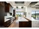 A gourmet kitchen featuring wood cabinets, stainless steel appliances, and a large marble-topped island at 41248 N 96Th St, Scottsdale, AZ 85262