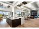 Open-concept kitchen with marble island, wooden cabinets, and a view of the Arizona desert at 41248 N 96Th St, Scottsdale, AZ 85262
