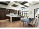 Modern kitchen with dark wood cabinets, breakfast bar, and adjacent dining area with scenic views at 41248 N 96Th St, Scottsdale, AZ 85262