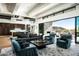 Elegant living room with modern furniture, a stone fireplace, and a seamless transition to outdoor living at 41248 N 96Th St, Scottsdale, AZ 85262