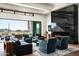 Open living room featuring a modern fireplace and large windows with stunning desert views at 41248 N 96Th St, Scottsdale, AZ 85262