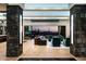 Spacious living room framed by stone columns, offering comfortable seating and stunning desert views at 41248 N 96Th St, Scottsdale, AZ 85262