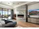 Spacious main bedroom featuring a fireplace, marble accent wall, and a private patio with desert views at 41248 N 96Th St, Scottsdale, AZ 85262
