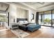 Bright main bedroom with hardwood floors, a seating area, and large windows showcasing the outdoor scenery at 41248 N 96Th St, Scottsdale, AZ 85262