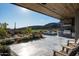 Expansive outdoor patio featuring a built-in kitchen, barbecue, and stunning views of the surrounding landscape at 41248 N 96Th St, Scottsdale, AZ 85262