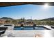 Stunning pool with dual waterfalls against a scenic desert and mountain backdrop at 41248 N 96Th St, Scottsdale, AZ 85262