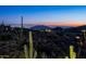 Scenic view of the desert landscape, including a dramatic sunset and towering saguaro cacti at 41248 N 96Th St, Scottsdale, AZ 85262