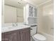This bathroom has a vanity with modern hardware and medicine cabinet over the toilet at 7494 E Earll Dr # 308, Scottsdale, AZ 85251
