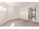 Well-lit bedroom features carpet, natural lighting and has access to the bathroom at 7494 E Earll Dr # 308, Scottsdale, AZ 85251