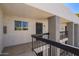 Exterior view of the condo building featuring second-floor entrance and balcony with dark metal railings at 7494 E Earll Dr # 308, Scottsdale, AZ 85251