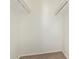 Empty closet with rails and carpeted floor at 7494 E Earll Dr # 308, Scottsdale, AZ 85251
