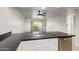 Features a kitchen island and sink, opening up to a living space with a sliding door to a patio at 7494 E Earll Dr # 308, Scottsdale, AZ 85251