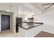Bright kitchen with white cabinetry, black countertops, stainless appliances, and breakfast bar seating at 7494 E Earll Dr # 308, Scottsdale, AZ 85251