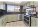 Stylish kitchen featuring stainless steel appliances, ample counter space and green cabinets at 8410 N 32Nd Ave, Phoenix, AZ 85051