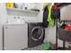 Functional laundry room with washer and dryer, ample shelving, and stylish tiled floor at 8410 N 32Nd Ave, Phoenix, AZ 85051
