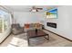 Bright living room with a ceiling fan, plush seating, modern fireplace, and a large window at 8410 N 32Nd Ave, Phoenix, AZ 85051