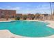 A community pool surrounded by fencing and adjacent to residential buildings, under a bright blue sky at 8410 N 32Nd Ave, Phoenix, AZ 85051