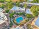 Aerial view of a community with a pool, lush landscaping, and multi-story buildings at 9451 E Becker Ln # 2013, Scottsdale, AZ 85260