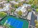 Aerial view of tennis court and condo community with manicured landscaping and covered parking at 9451 E Becker Ln # 2013, Scottsdale, AZ 85260