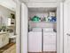 Convenient laundry area with a washer, dryer, and storage shelves at 9451 E Becker Ln # 2013, Scottsdale, AZ 85260