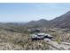 Aerial view of a modern home on a hillside with mountain and desert views at 9643 E Cintarosa Pass, Scottsdale, AZ 85262