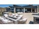 The backyard has an outdoor fireplace, ample seating, and a desert landscape with mountain views at 9643 E Cintarosa Pass, Scottsdale, AZ 85262