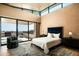 Bright bedroom featuring high ceilings, a sitting area, and a private balcony overlooking the landscape at 9643 E Cintarosa Pass, Scottsdale, AZ 85262