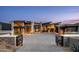 Modern home exterior with stone accents, large windows and a spacious driveway behind a gated entry at 9643 E Cintarosa Pass, Scottsdale, AZ 85262