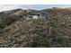 Desert luxury home situated on hillside with mountain views and natural desert landscaping at 9643 E Cintarosa Pass, Scottsdale, AZ 85262
