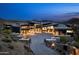 Modern estate with impressive stone accents, a paved driveway, and a landscaped desert setting at 9643 E Cintarosa Pass, Scottsdale, AZ 85262