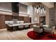 Gourmet kitchen with breakfast bar, modern lighting, wood cabinetry, and a view to the dining area at 9643 E Cintarosa Pass, Scottsdale, AZ 85262