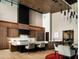 Modern kitchen with wood cabinetry, a breakfast bar, modern lighting, and an open design at 9643 E Cintarosa Pass, Scottsdale, AZ 85262